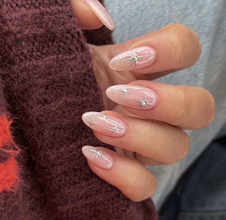 Chic Nude Nails with Whimsical Silver Star Accents and Sophisticated Gradient.