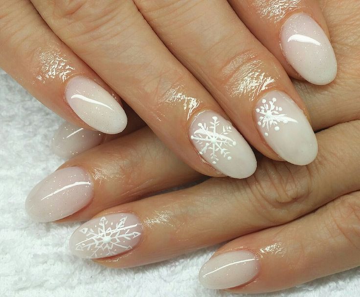 Elegant Winter Nail Art with Frosted White Base and Delicate Snowflake Designs.