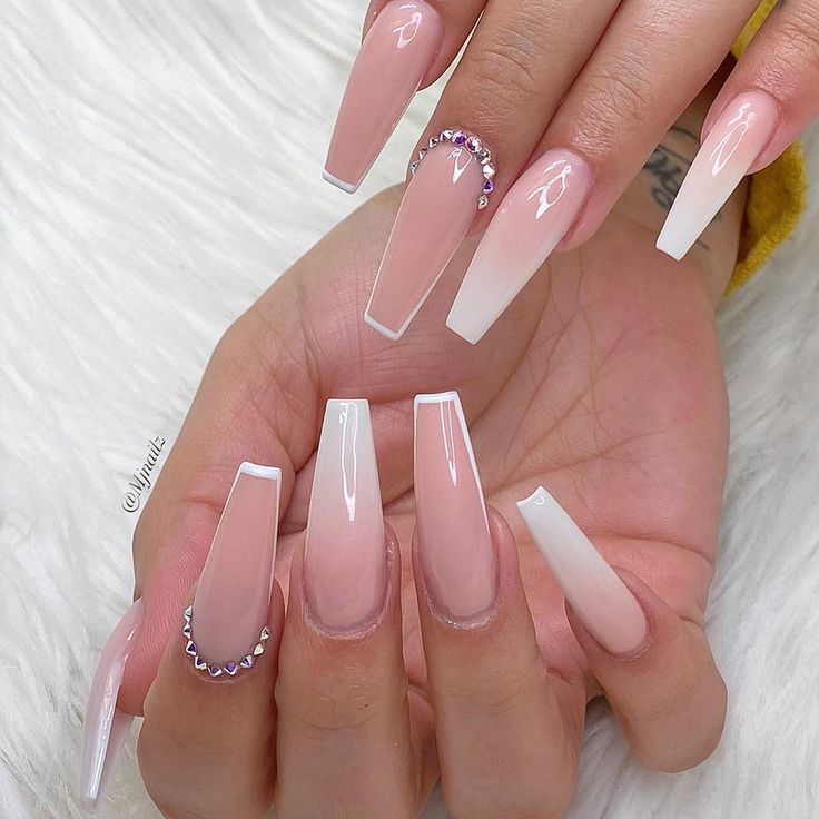 Sophisticated French Tip Nail Design with Nude and White Shades Accented by Rhinestones.