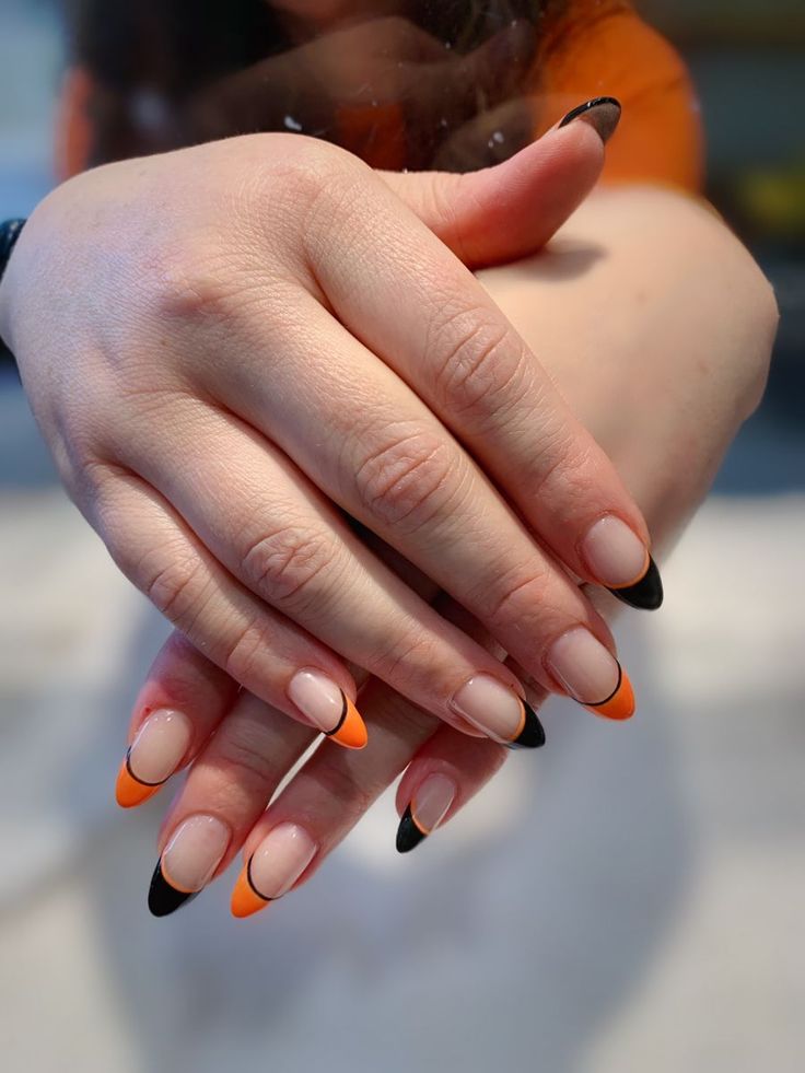 Chic Modern French Tip Nail Design: Striking Nude, Orange, and Black Contrast for Any Occasion.