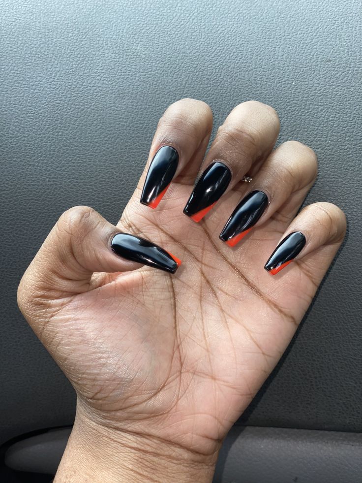 Striking Elegant Black Nails with Bold Red Tips: A Perfect Blend of Edge and Style.