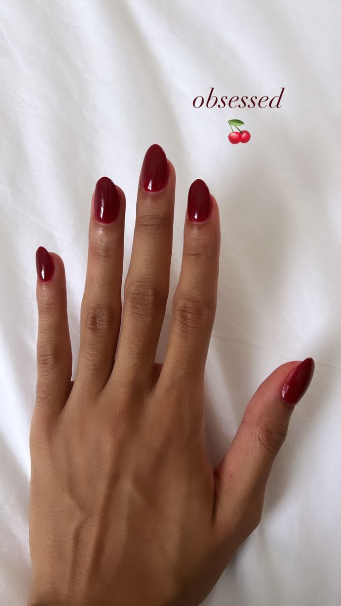 Sophisticated Elegant Red Nail Design: Glossy Almond-Shaped Statement Look.