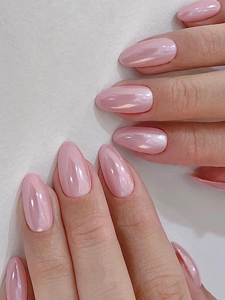 Elegant Glistening Pink Almond Nails with Glossy and Iridescent Gradient Finish.