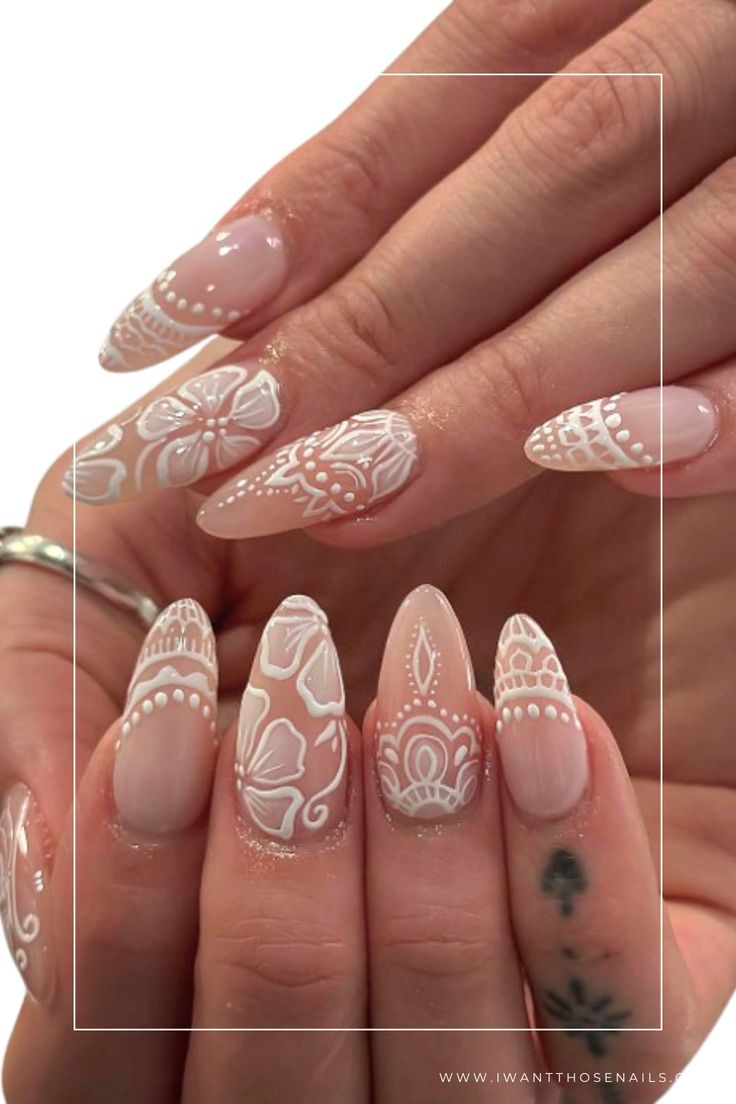 Sophisticated Soft Nude Nail Design with Intricate Floral and Geometric Patterns