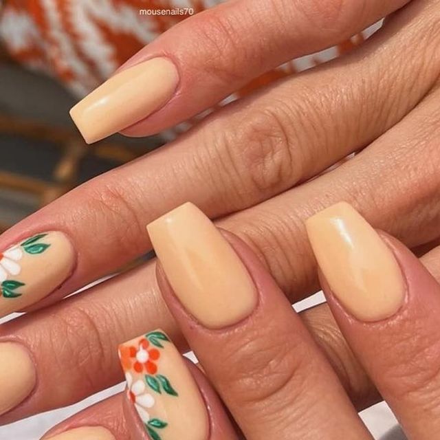 Elegant Floral Accents on a Soft Nude Nail Design for Any Occasion.