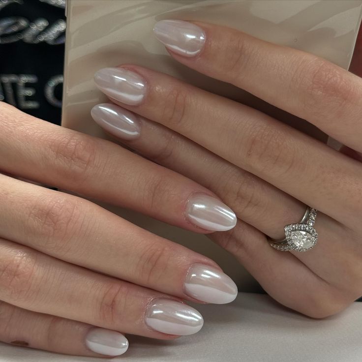 Sophisticated Almond-Shaped Nails with Milky White Finish: A Chic and Elegant Choice for Any Occasion.