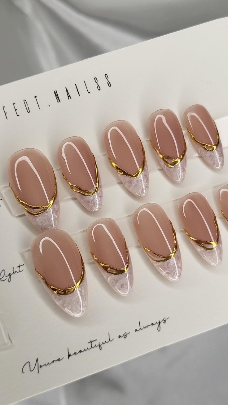 Modern Chic: Elegant Nude Nail Design with Glossy Finish and Gold Accents.