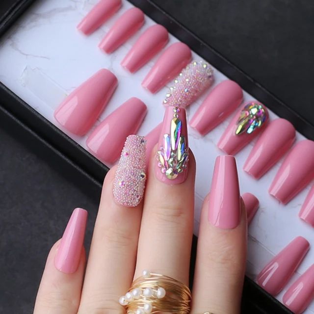 Glamorous Pink Nail Art with Glossy Textures and Shimmering Gem Accents.