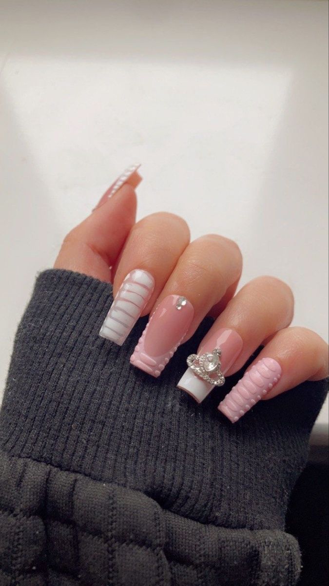 Elegant Soft Pink and White Nail Design with Textured Patterns and Rhinestone Accents.