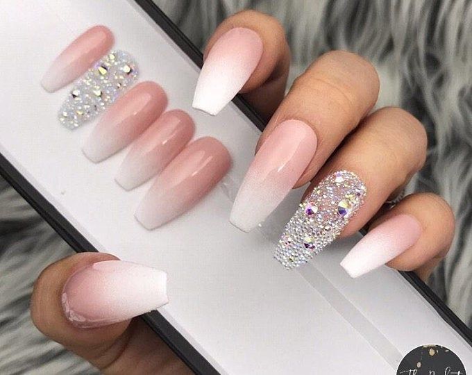 Luxurious Ombre Pink and White Nail Design with Glitter and Rhinestone Accents