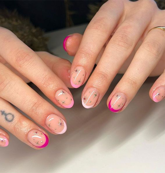 Chic Nail Design with Soft Pink, Bold Neon Tips, and Whimsical Star Patterns.