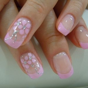 Charming Elegant Pink French Tip Nail Design with Floral Patterns and Glossy Finish.