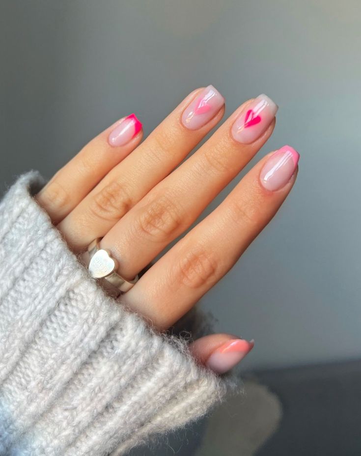 Charming Nail Design: Soft Pink with Bold Accents and Heart Shapes, Perfectly Styled with a Cozy Sweater.