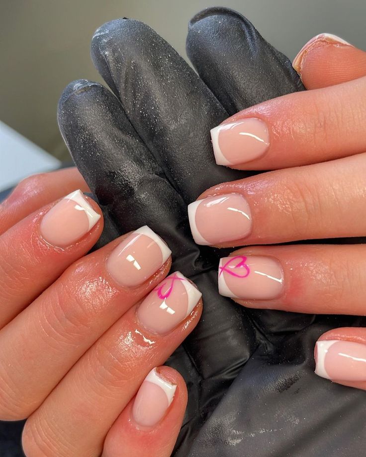 Chic French Tips with Playful Pink Designs for a Sophisticated Nail Art Look.