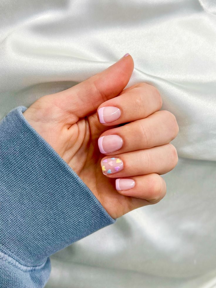 Chic Pastel Nail Design: Elegant French Tips with Playful Geometric Accent.