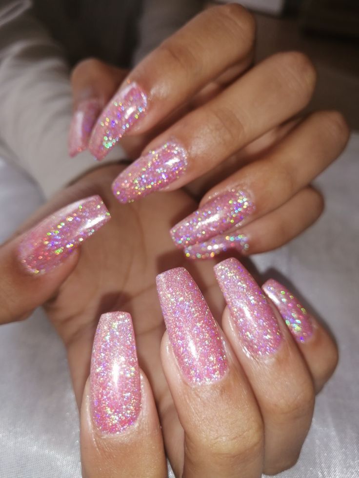 Whimsical Elegance: Glittery Pink Nails with Holographic Sparkles for Festive Charm.