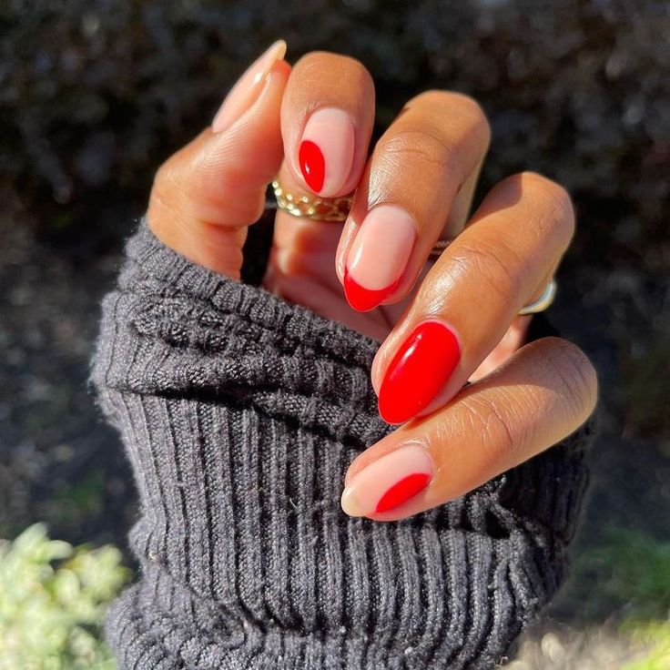 Elegant Red and Nude Nail Design: A Modern Take on French Manicure with Bold Tips.