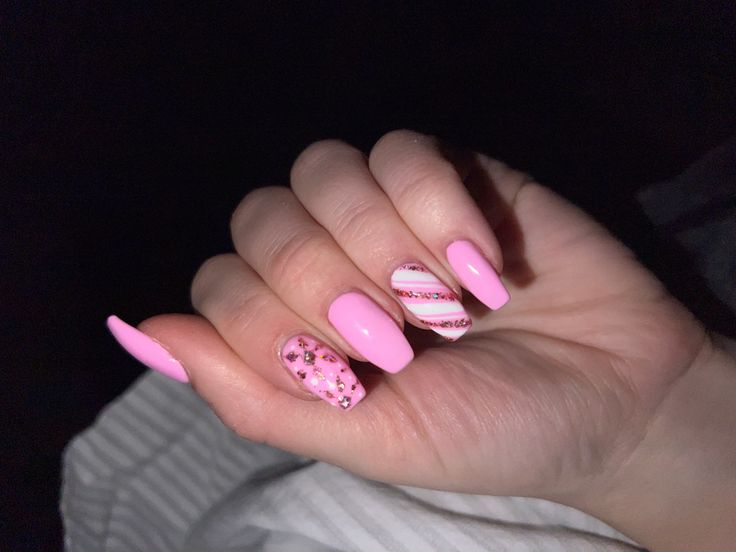 Whimsical Chic Pink Manicure with Floral and Candy Striped Accents.