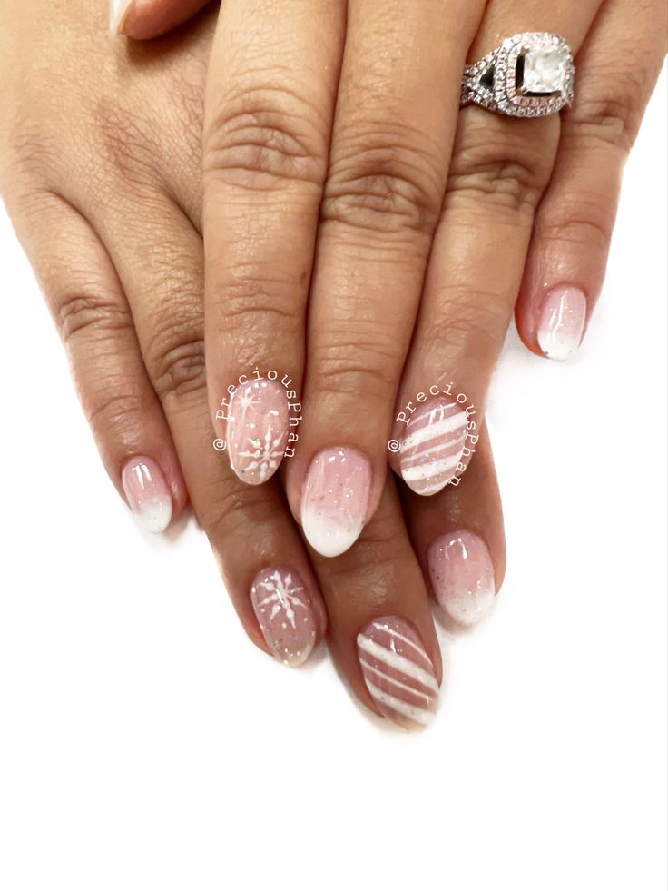 Elegant Pink and White Gradient Nail Design with Intricate Patterns and Glossy Finish.