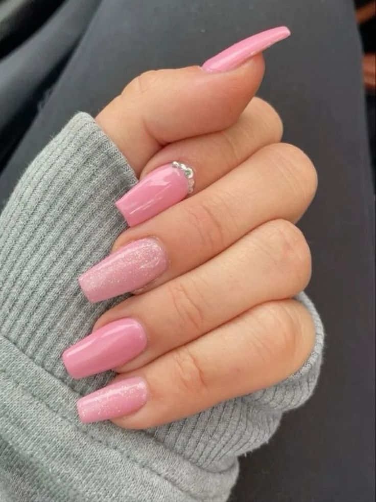 Chic Elegant Nail Design with Glossy Pink Finish and Glamorous Accents.