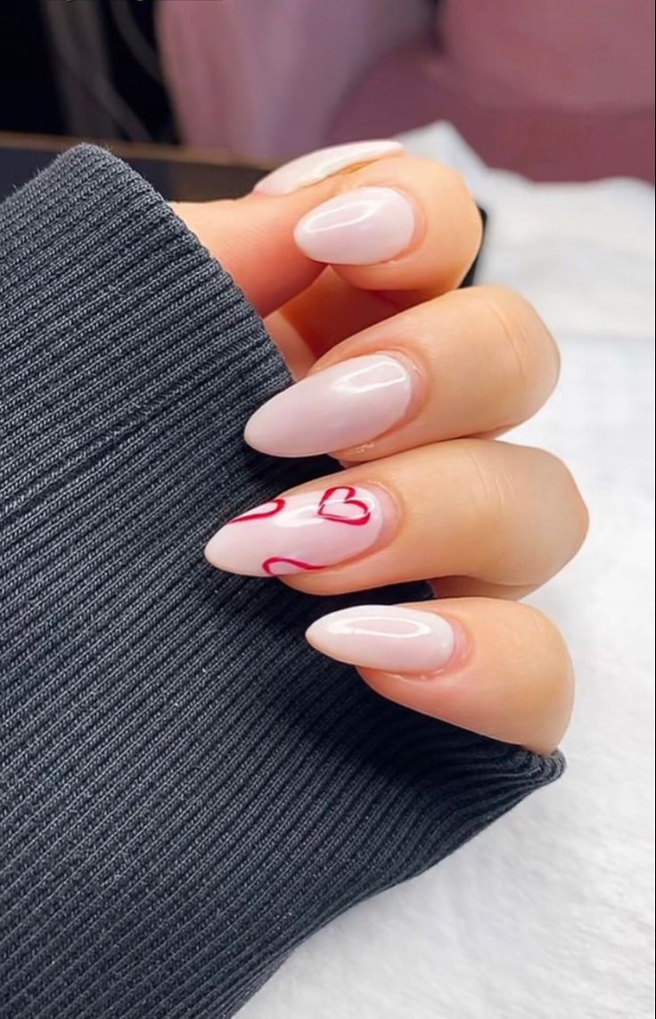 Sophisticated Almond-Shaped Nude Nails with Playful Red Heart Accent