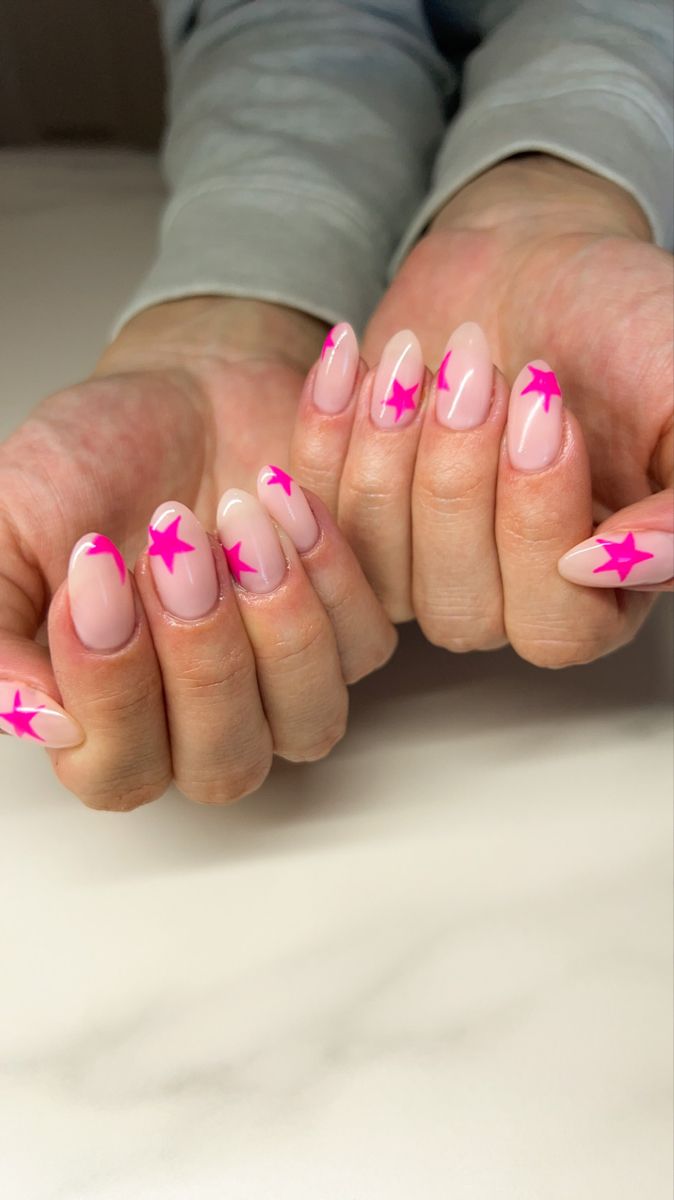 Playful Nude Nail Design with Bright Pink Star Accents