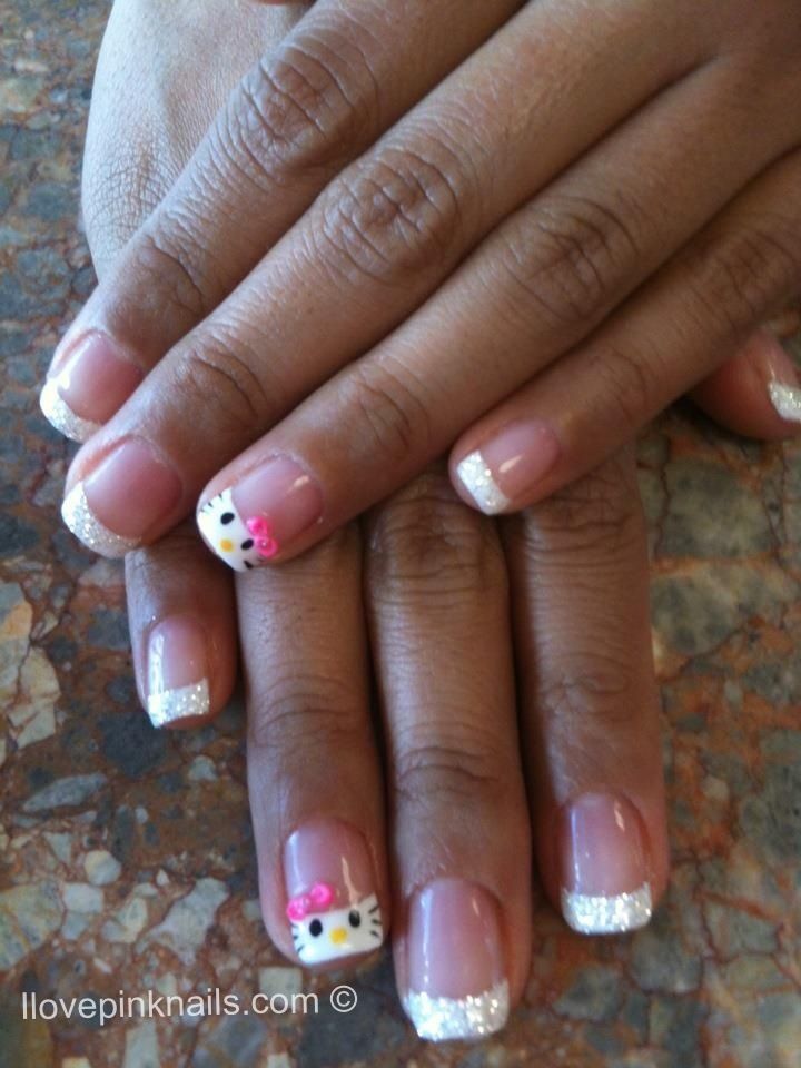 Whimsical French Tip Nail Design with Sparkling Silver and Adorable Hello Kitty Motifs