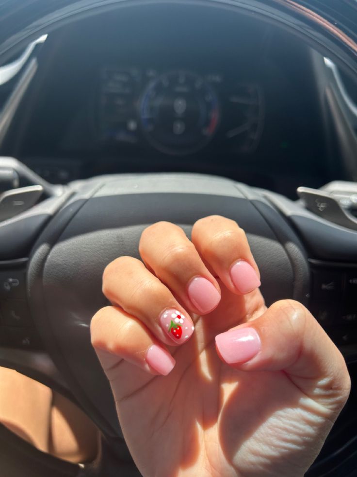 Cheerful Summer Nail Art: Delicate Pink with Playful Cherry Design.