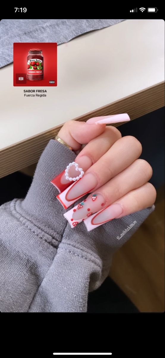 Playful and Festive Nail Design: Bold Red and Soft Pink with Heart Shapes and Gem Accents.