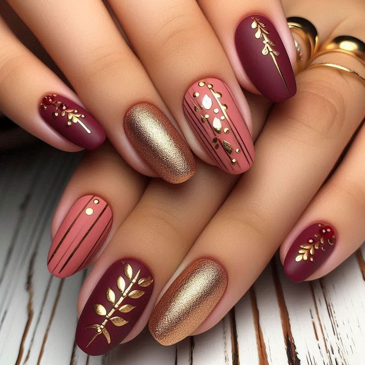 Sophisticated Elegance: Burgundy Matte and Glossy Nail Design with Gold Leaf Accents