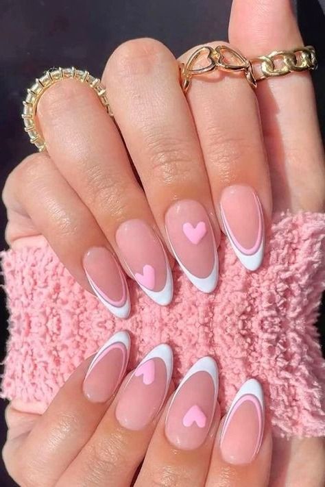 Chic Nude and White Nail Design with Heart Motifs and Elegant Almond Shape