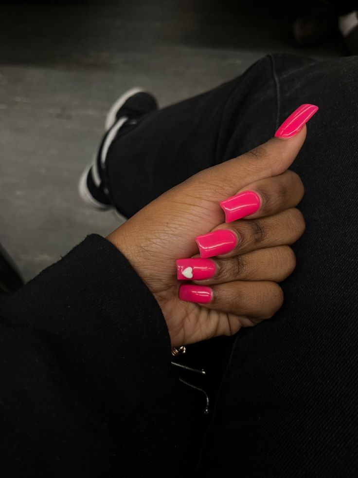 Bold Vibrant Pink Nails with Charming Heart Design for a Fun, Trendy Look.