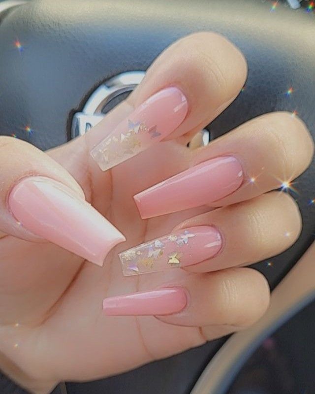 Elegant Soft Pink Nail Design with Clear Tips and Gold Star Accents.