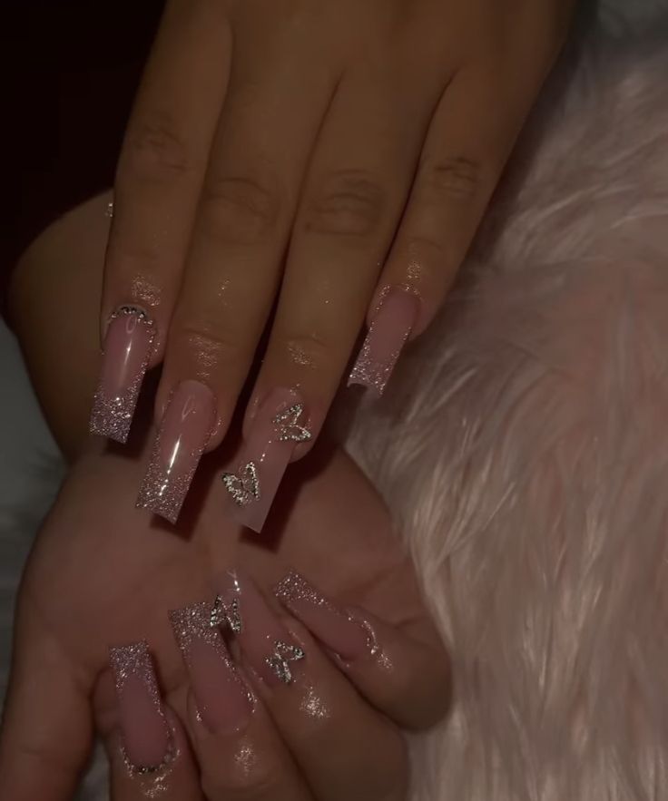 Elegant Long Pink Nails with Glitter Accents and Decorative Charms