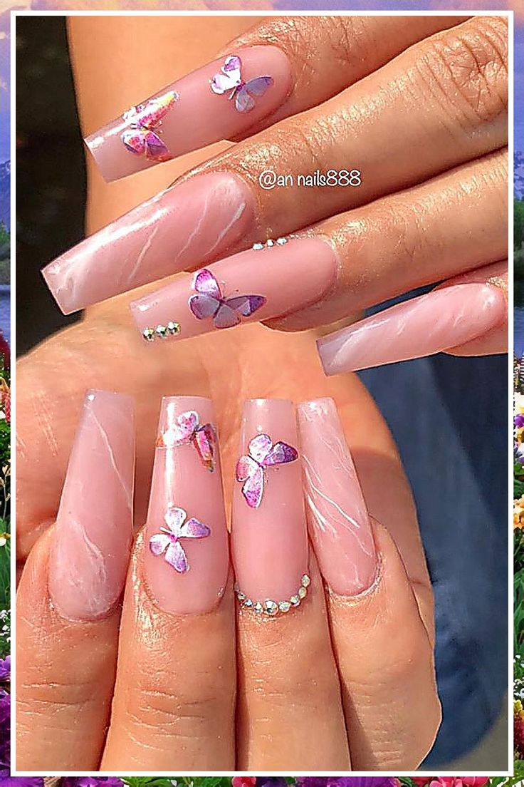 Sophisticated Soft Pink Nail Design with Butterfly Accents and Glamorous Rhinestones