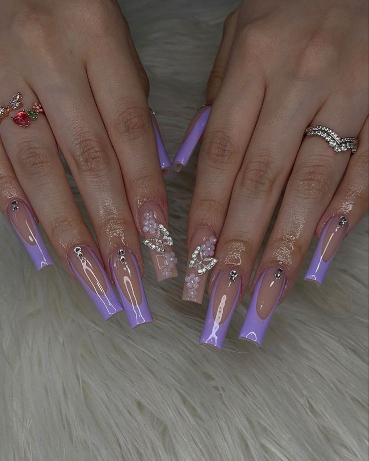 Elegant Lavender Nail Design: Glossy Coffin Shape with Intricate Embellishments and Butterfly Motifs.