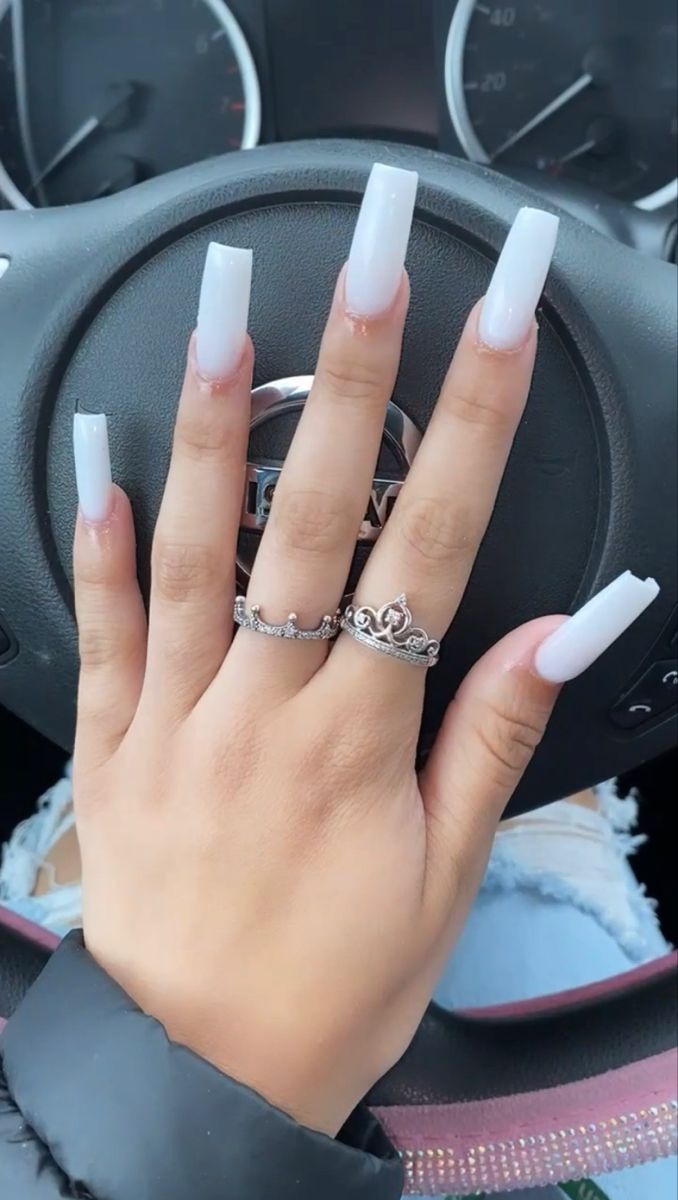 Elegant White Ombre Long Nails with Glossy Finish and Complementing Rings.