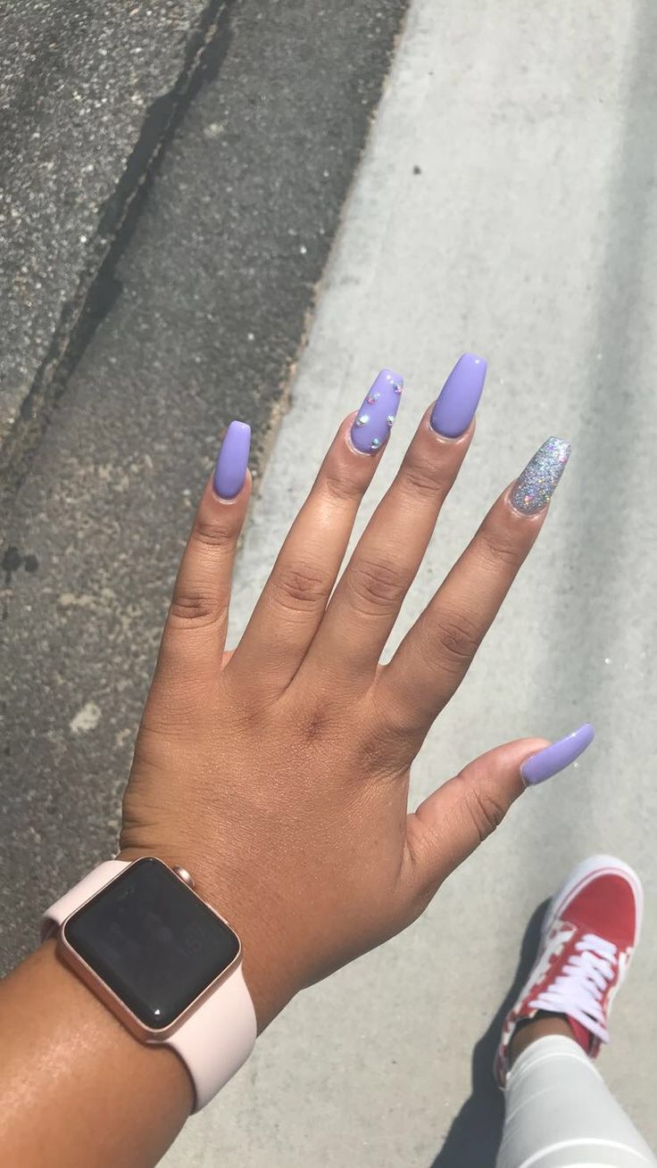 Elegant Lavender Oval Nails with Sparkling Accent and Delicate Embellishments.