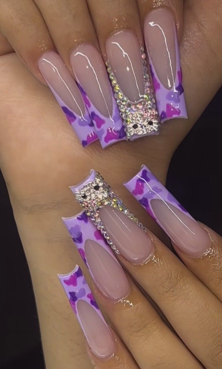 Trendy Lavender Nail Design with Glossy Tips, Heart Shapes, and Glamorous Rhinestone Embellishments.