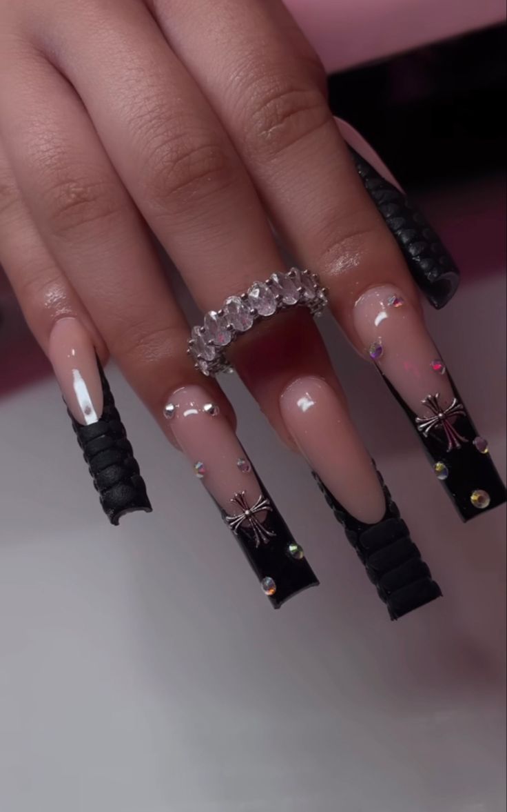 Chic Almond Shaped Acrylic Nails with Black Tips and Glamorous Embellishments.