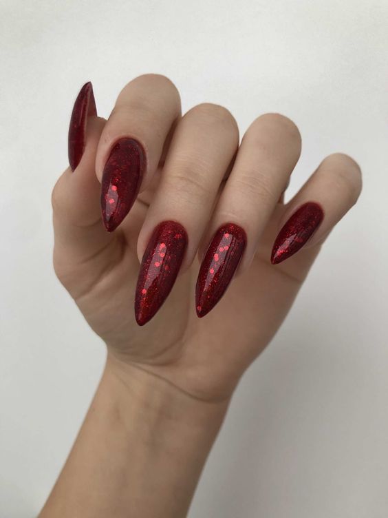 Edgy Glamour: Stunning Red Glitter Nails for Special Occasions.