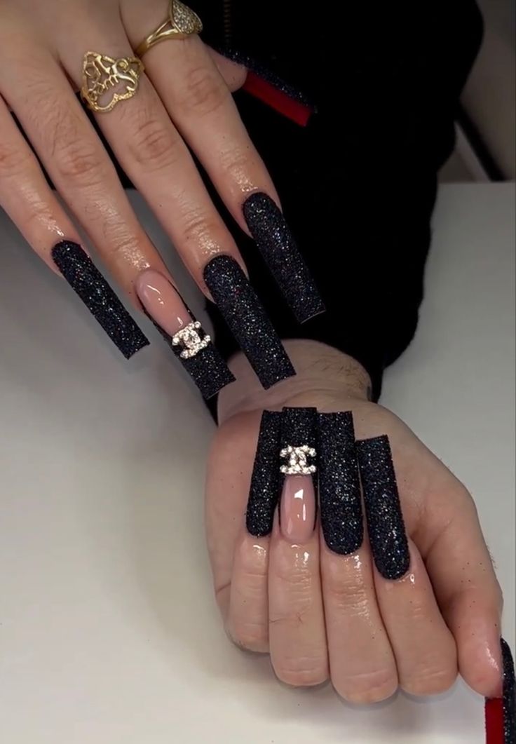 Striking Black Glitter Nail Design: A Perfect Blend of Elegance and Boldness for Glamorous Occasions.