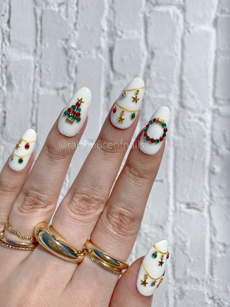 Elegant Holiday Nail Design with Festive White Tips and Vibrant Red and Green Embellishments.