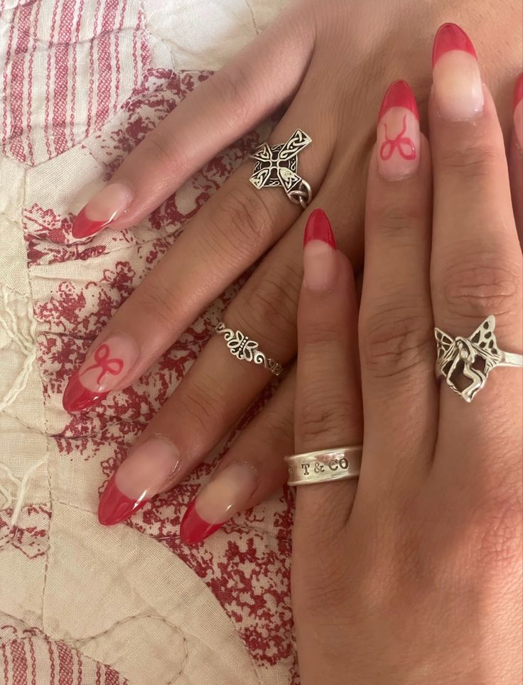 Chic Red French Tip Nails with Whimsical Pink Bows and Silver Ring Accents