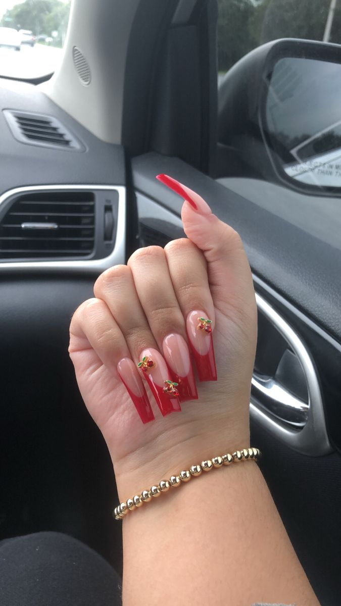 Elegant Nude and Bold Red Nail Design with Whimsical Floral Accents