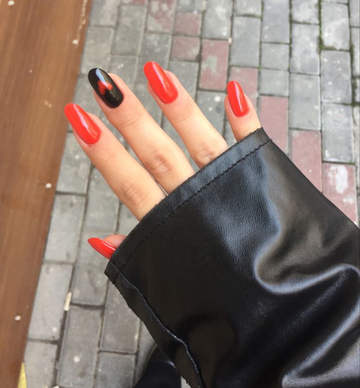 Striking Red and Black Almond Nail Design: Elegant Boldness with Glossy Sophistication.