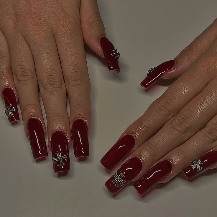 Chic Burgundy Nails with Glossy Finish and Glamorous Silver Charms.