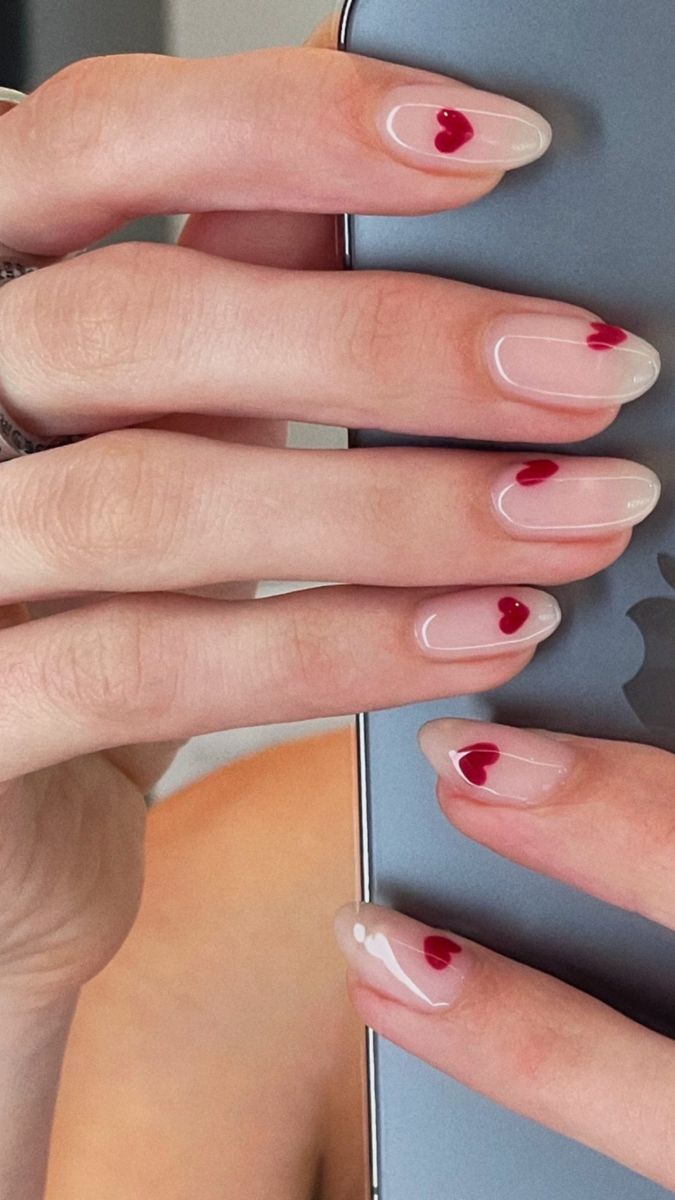 Charming Minimalist Nail Design with Nude Base and Playful Red Heart Accents.