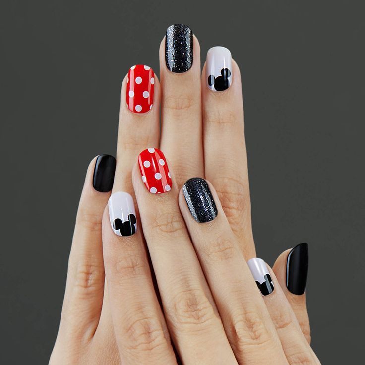 Charming Playful Nail Design with Colorful Patterns and Mickey Mouse Silhouettes.