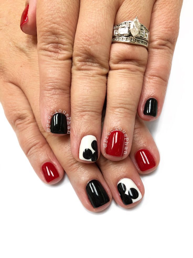 Bold Red, Black, and White Nail Design with Abstract Patterns and Heart Accents.